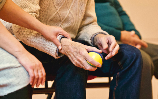 Woman holding elderly man's arm